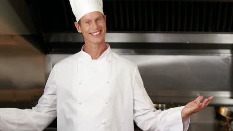 Handsome-man-showing-kitchen-and-doing-ok-sign