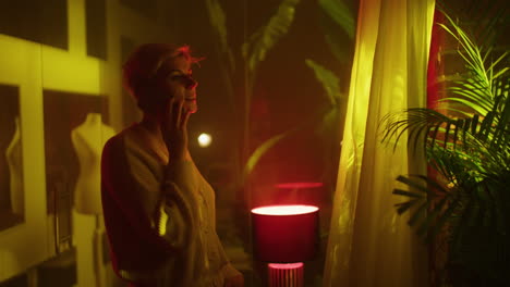 woman in a cozy neon-lit room