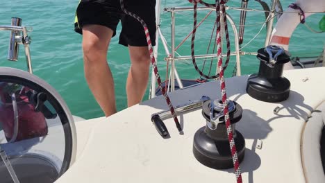 sailor handling mooring lines on a yacht