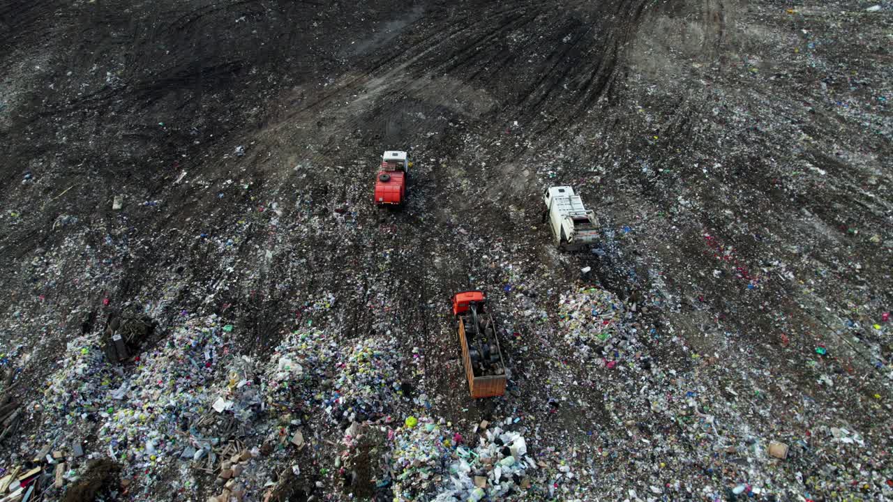 Aerial View of Landfill with Garbage Trucks