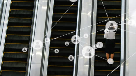 animation of network of connections with icons over businesswoman on escalator