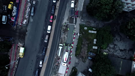 Cement-mixer-and-crew-putting-in-a-concrete-sidewalk---straight-down-aerial-descending-spinning-view