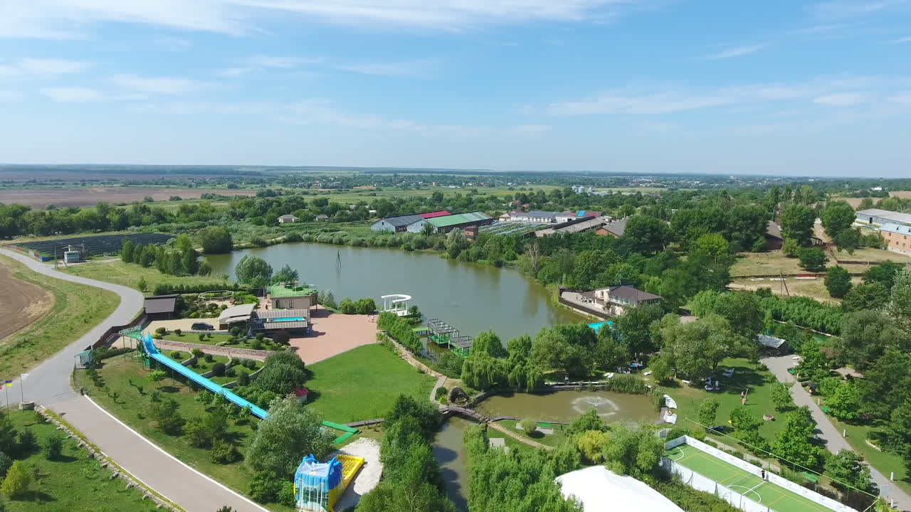 Beautiful recreational area in the countryside. Well-kept territory with cute buildings and little pond inside. Top view.