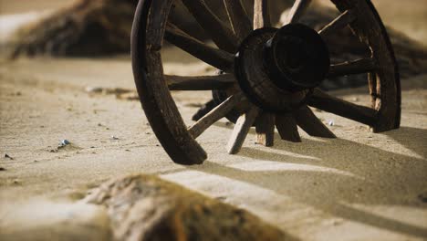 large wooden wheel in the sand