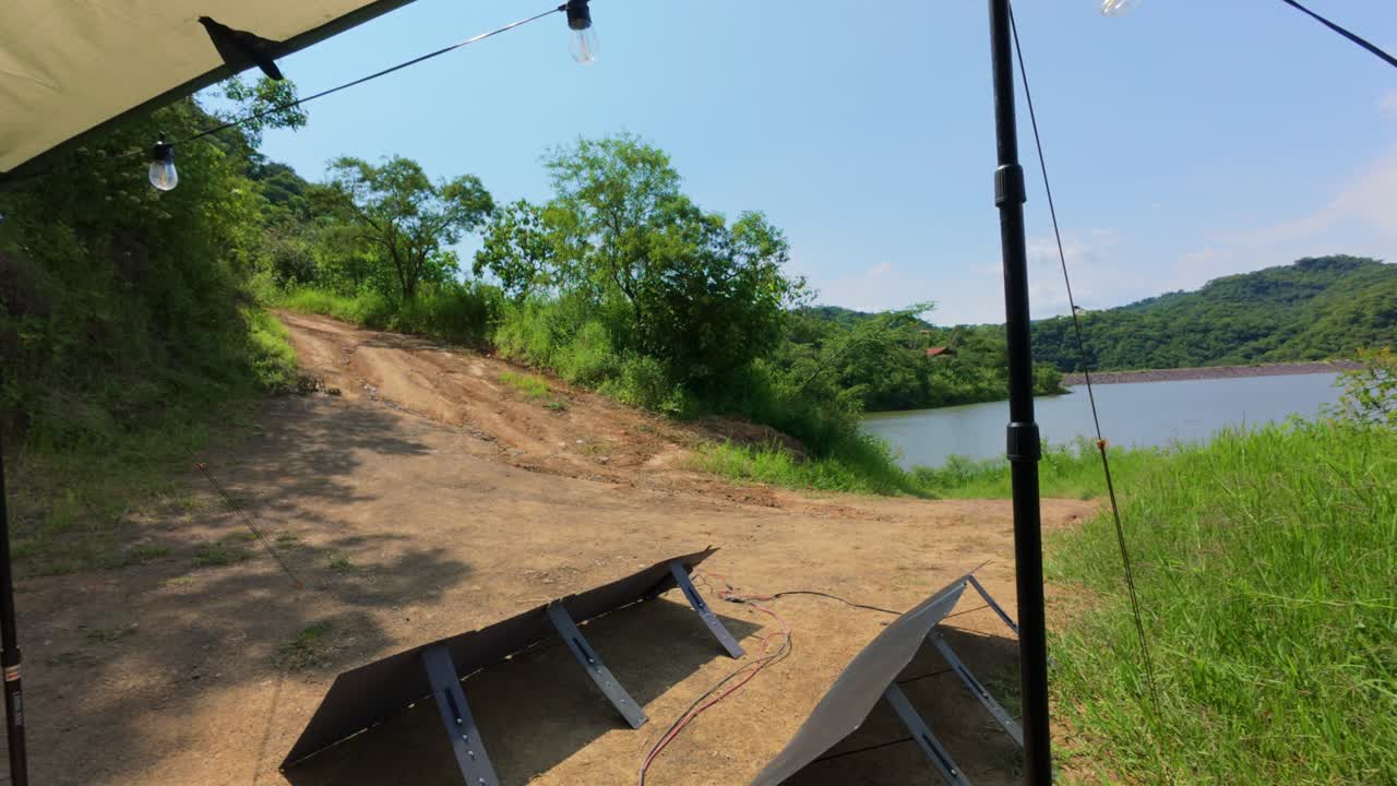 Footage of Presa El Carrizo, Jalisco shows tranquil lake, green landscape, and solar panels in bright daylight. Perfect for eco-tourism, nature, and sustainable energy themes