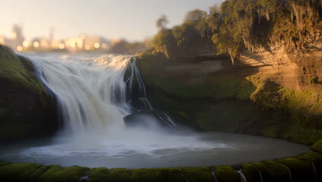 Majestic Waterfall Landscape with Distant City Lights