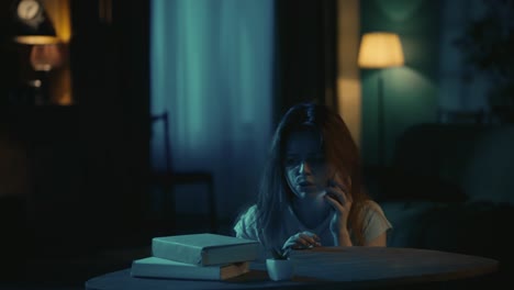 afraid young girl with baseball bat standing near the window runs to the table and calls to police - horror movie scene in the apartment creative concept. afraid young girl with baseball bat standing near the window, runs to the table and calls to police on smartphone, talking, maniac walking around