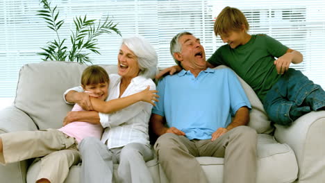 Children-jumping-on-grandparents-on-the-couch