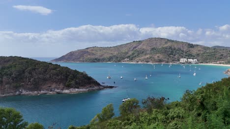 drone footage captures serene ocean views and boats near cape promthep, phuket, under clear skies and bright sunlight