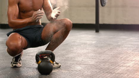 Fit-man-chalking-his-hands-in-gym