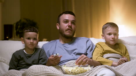 father and sons watching movie