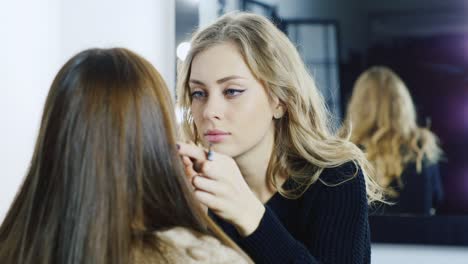 makeup artist young woman's make up in a studio