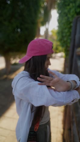 young woman posing near a wooden fence