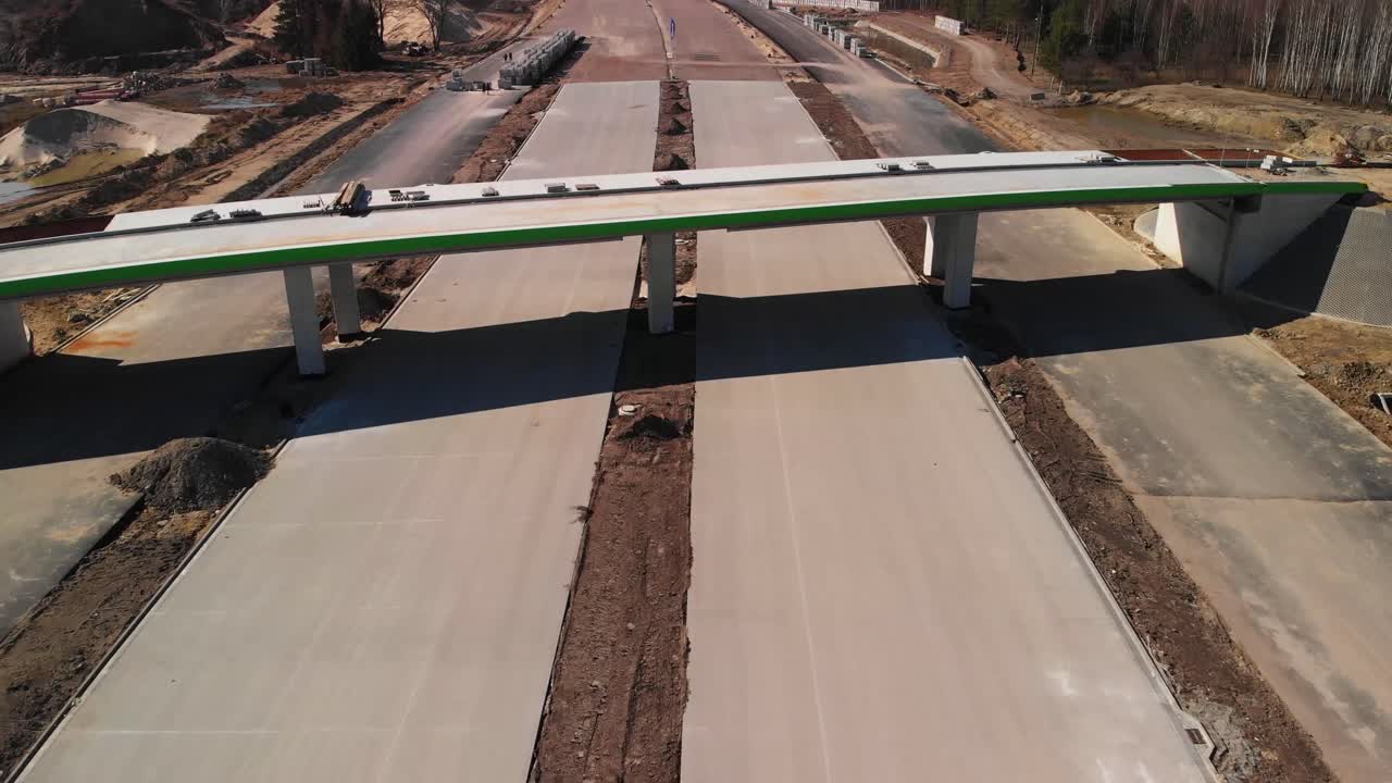 Aerial fly over the highway under construction and new concrete viaduct