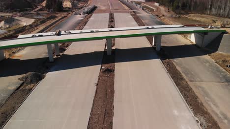 aerial fly over the highway under construction and new concrete viaduct