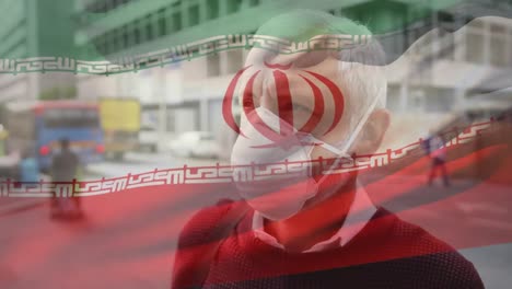 Animation-Der-Iranischen-Flagge,-Die-Während-Der-Covid-19-Pandemie-über-Einem-Mann-Mit-Gesichtsmaske-Winkt