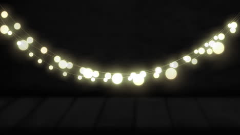 animation of yellow round shaped glowing fairy lights hanging against copy space on black background