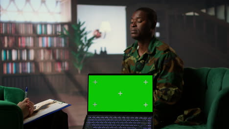 army veteran at counseling shares war related anxiety next to isolated screen