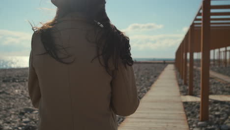 woman walking along a beach path