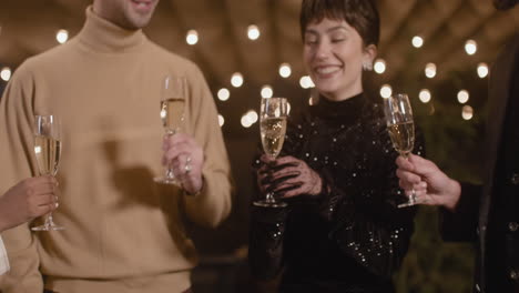 happy friends toasting and drinking champagne at new year's eve party