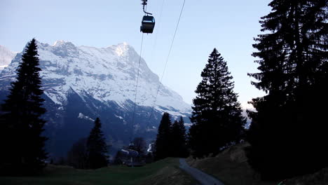 silhouette of cable cars going up to switzerland mountains