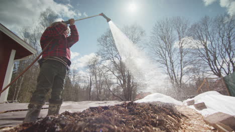 slow motion, backlit - stunning shot of a young child watering the beds