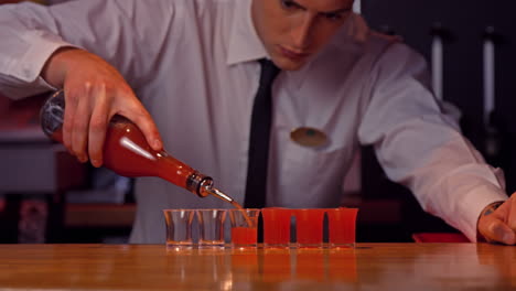 bartender pouring shots on counter