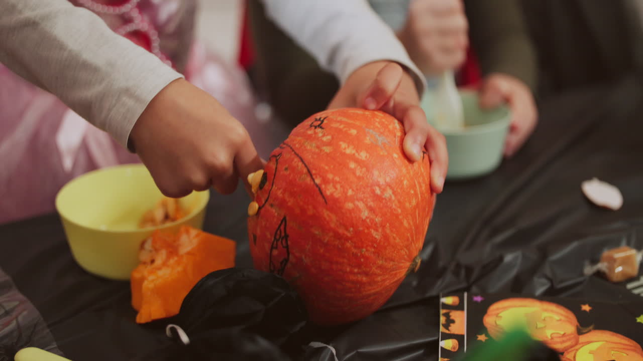 Children Carving Pumpkins for Halloween