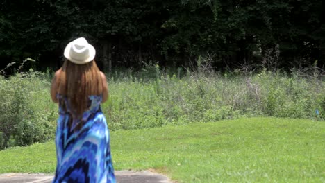 African-American-woman-rack-focus,-praying-outdoors-on-a-sunny-day