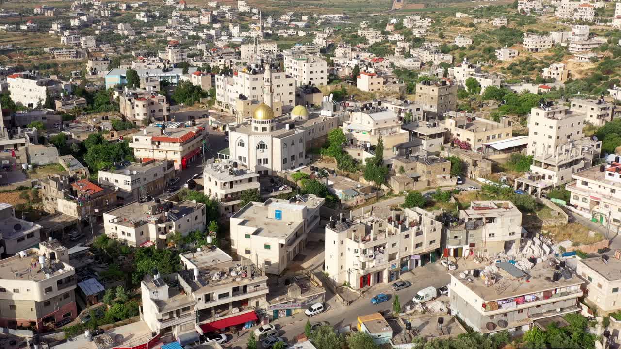 Aerial View of a Middle Eastern Town with a Mosque and Golden Domes