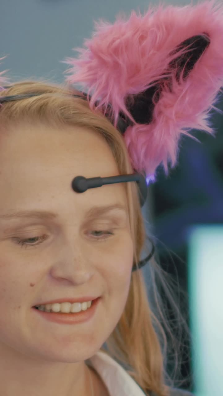 Woman wearing pink bunny ears and EEG headset