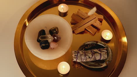 a crystal and smudge tray with candles
