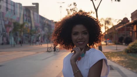 beautiful happy black afro brazilian woman walking and twirling, slow motion