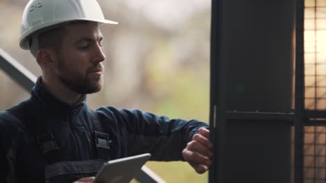 Close-up-of-a-male-electrician-conducting-a-technical-inspection-of-an-electrical-panel