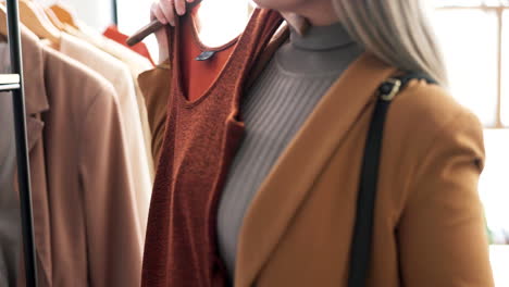 woman, hands and clothes on rack in shopping