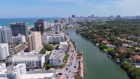 miami beach bridge, indian creek waterway, oceanfront hotels, downtown miami skyline in background, florida. aerial forward