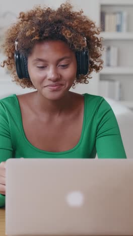 engaging young woman shares insights while working at home on laptop