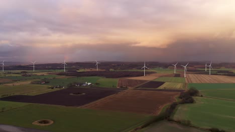 aerial view of wind turbine park on green fields