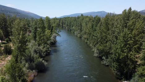 aerial view over sil river and a bridge, in o barco de valdeorras, galicia, spain - reverse, drone shot