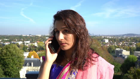 Happy-young-woman-talking-on-the-cell-phone