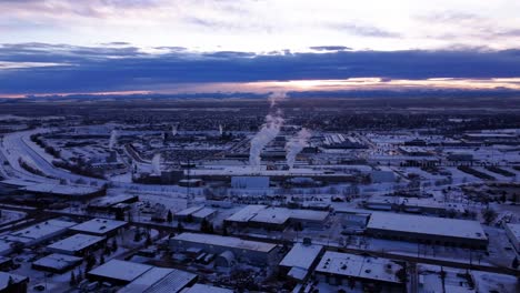 Aerial-Shot-of-Industrial-Zone-with-Steaming-Pipes