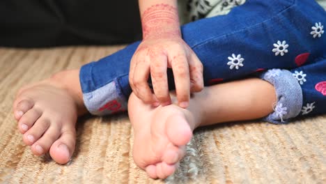 child with henna and scratching