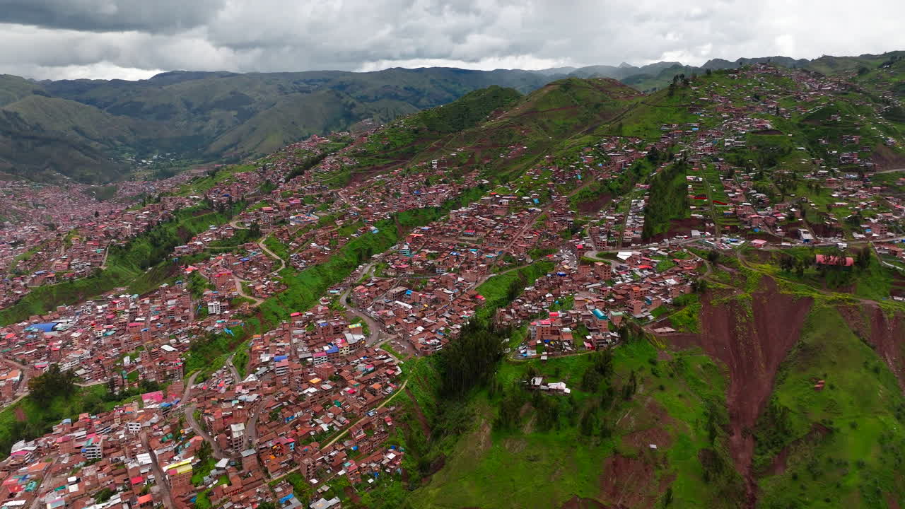 Drone Shot Cusco city in Peru Hillside Neighborhoods Set Against a Green Mountain
