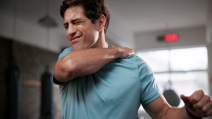 Man experiencing shoulder pain after exercise