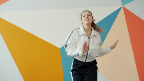 teenage girl dancing in trendy outfit