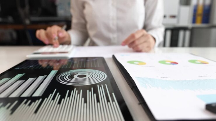 Marketer studies business statistics in graphs