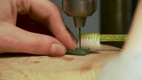 Close-up-of-drilling-hole-into-greenstone-from-New-Zealand-and-cooling-drill-with-water-on-tooth-brush