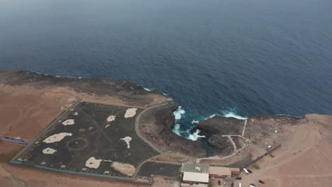 Atlantic-coast-on-Sal-Island,-Cape-Verde,-volcanic-stone-contrasting-with-the-Atlantic-Ocean