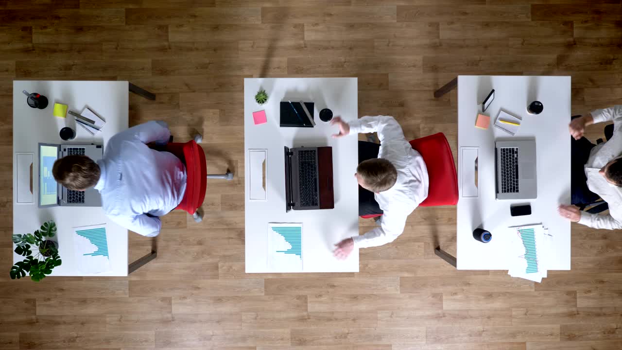 Three young businessman come to workplace with coffee simultaneously, work concept, office concept, communication concept, top shot
