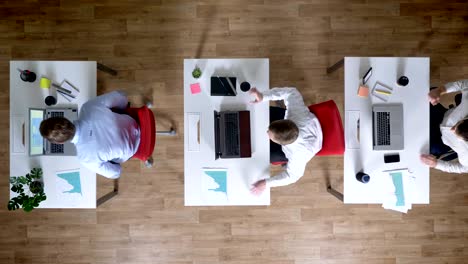 three young businessman come to workplace with coffee simultaneously, work concept, office concept, communication concept, top shot